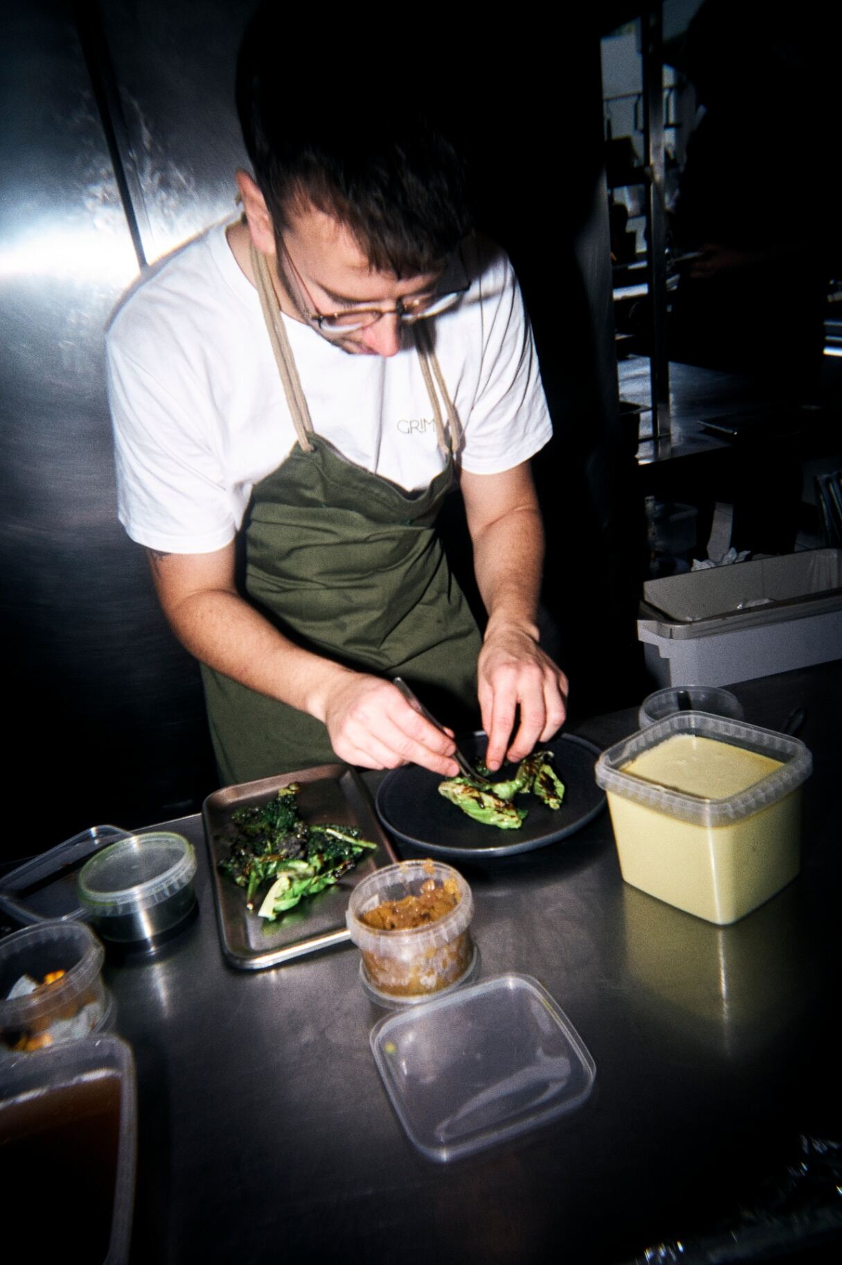 Køkkenchef Casper Nielsen anretter en ret i køkkenet på Restaurant Grim