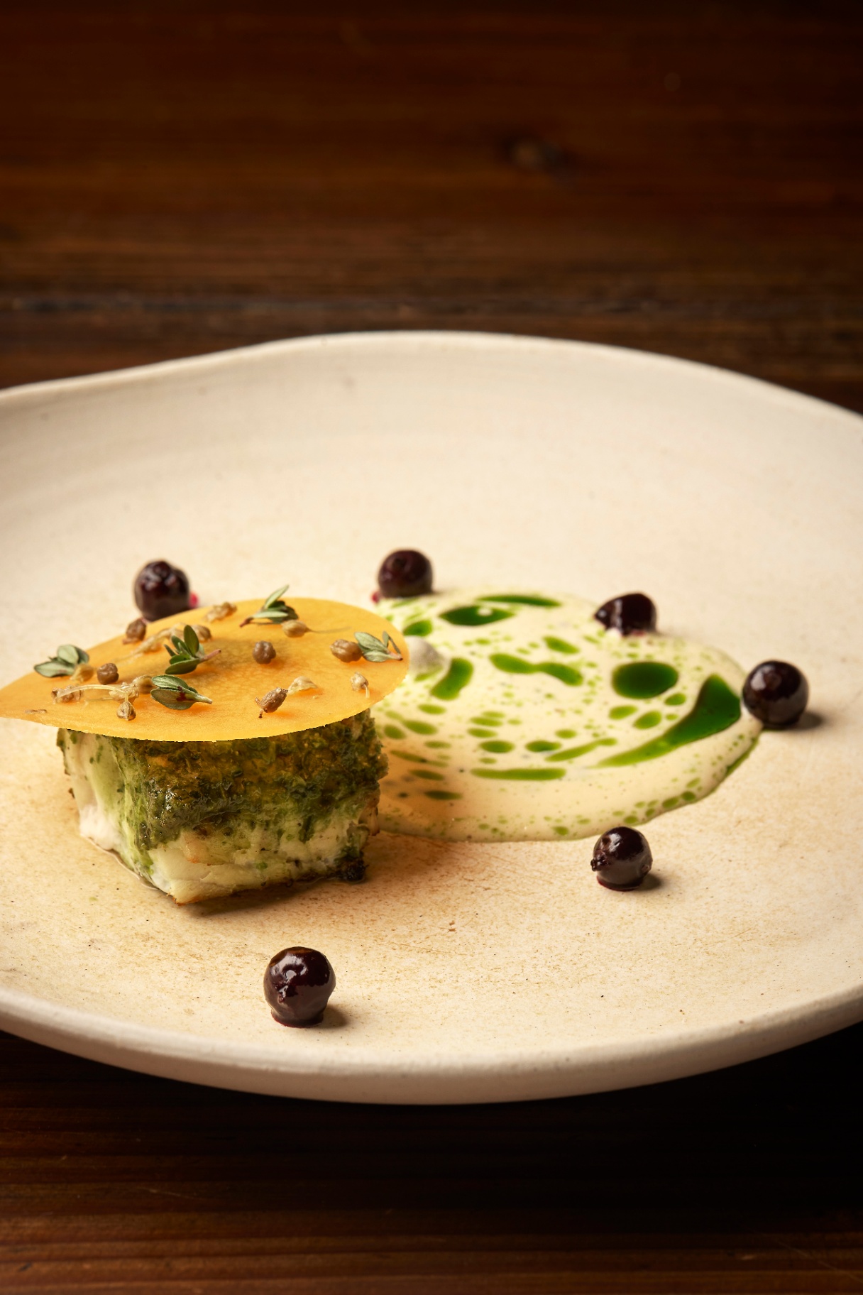 Grilled fish with herbs, crisp and pickled berries