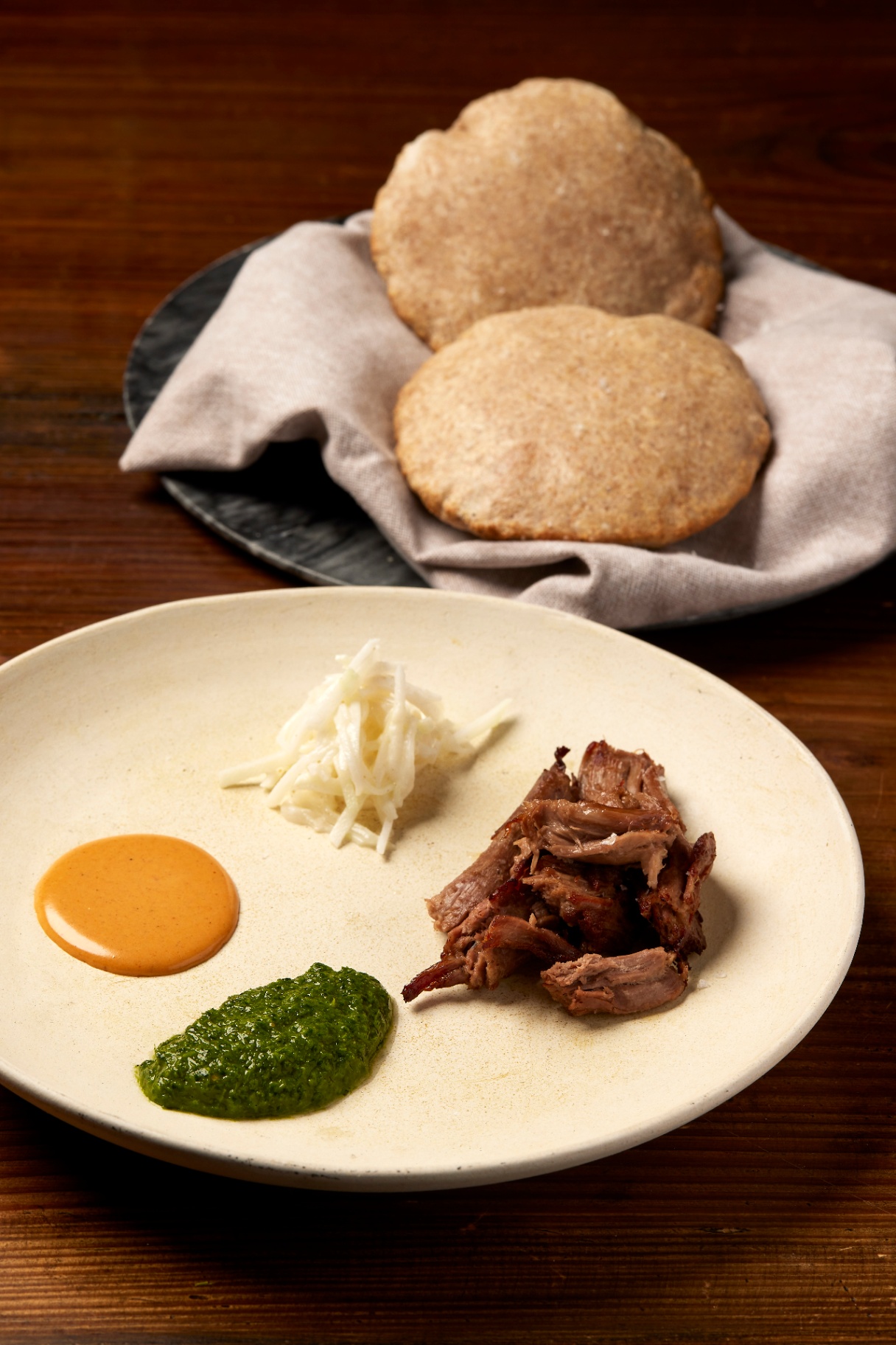 Braised lamb with flatbread, herb oil and celeriac